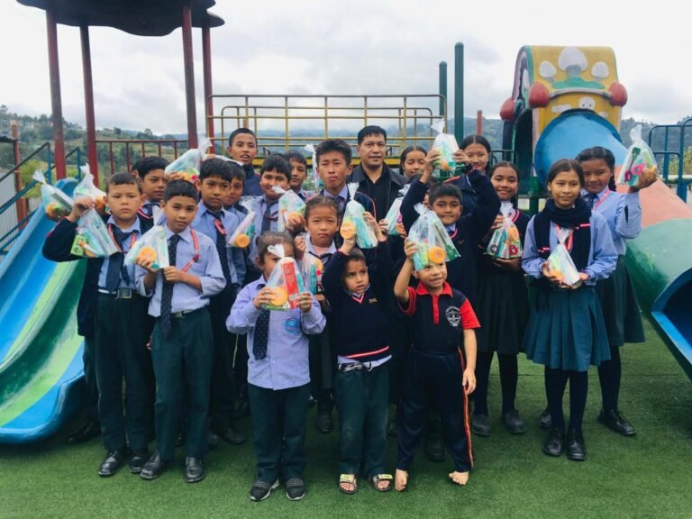 Students holding their school supplies in the school yard