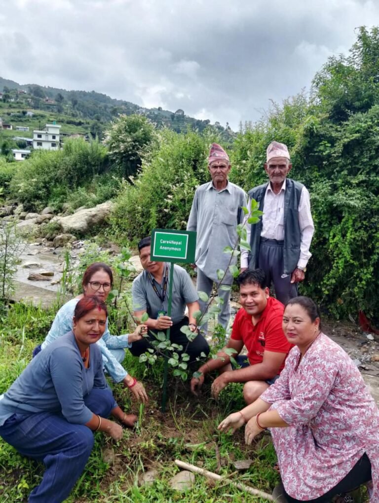 Community members beside newly planted trees